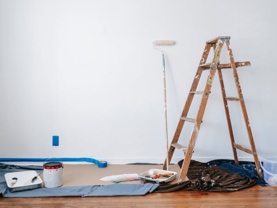 brown wooden ladder beside painting materials